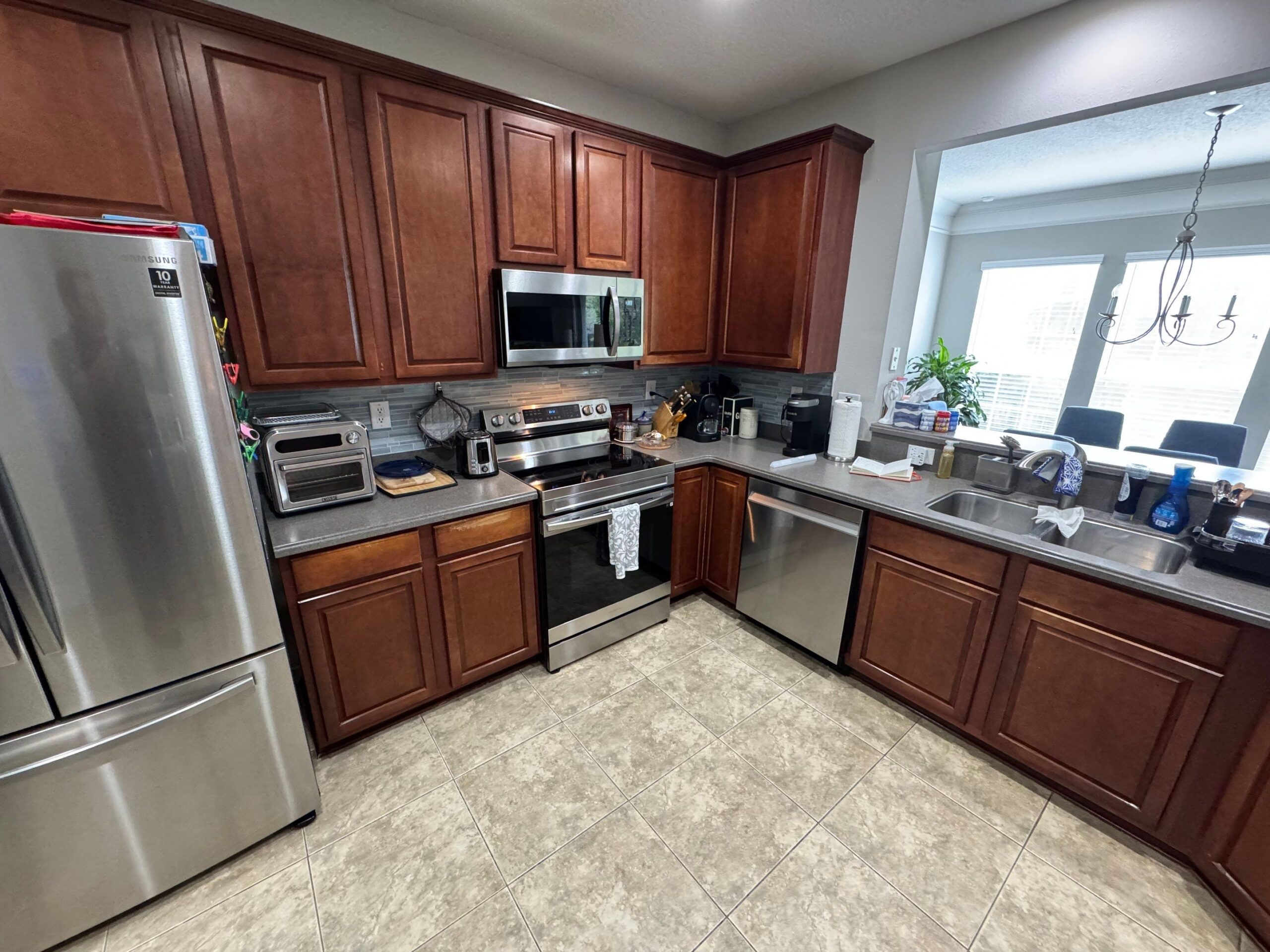1-Sep 09 2025 03_12pm-CUbx Custom cabinets Jacksonville kitchen with white shaker cabinets, stainless appliances, and a large island with seating