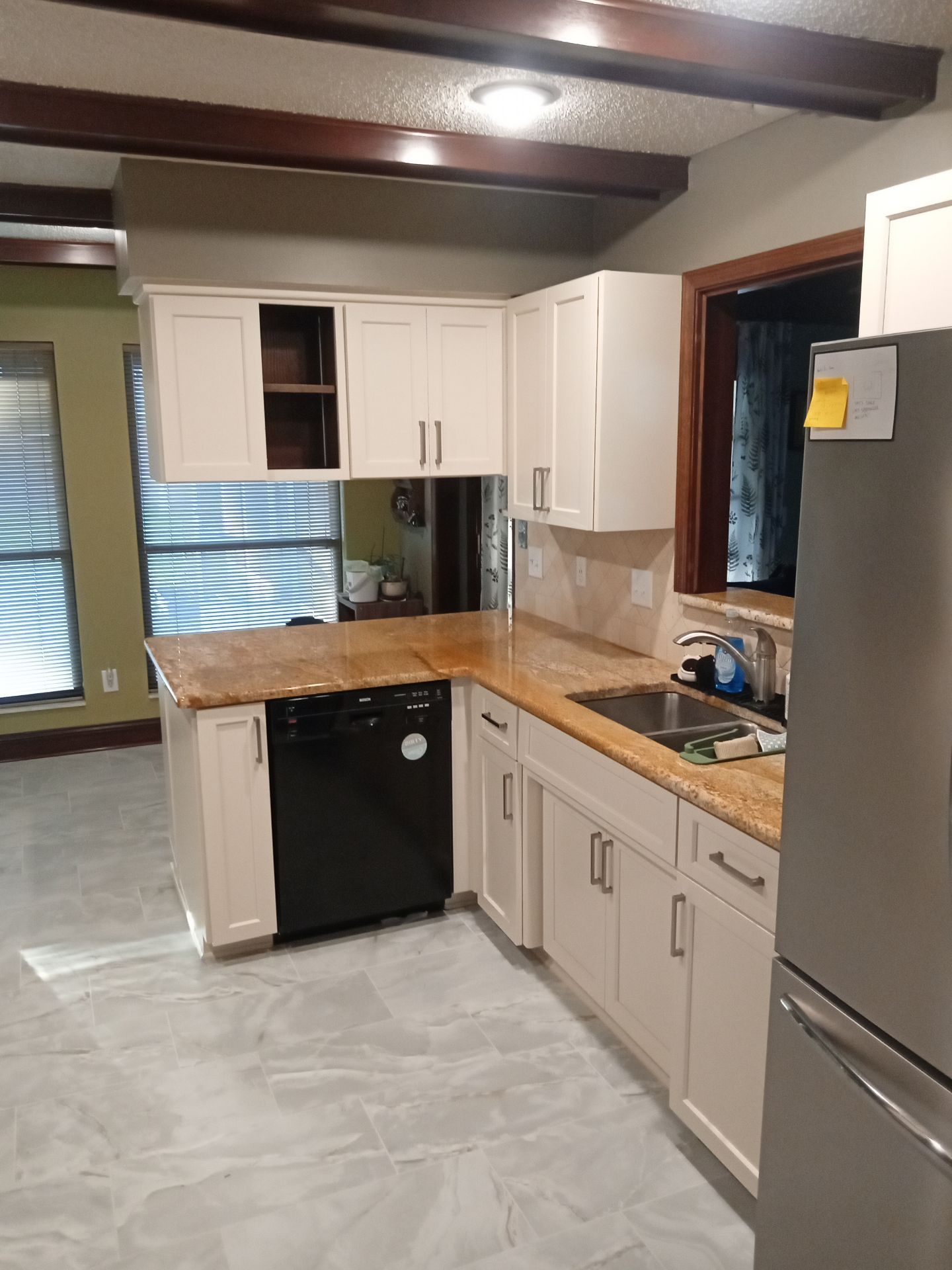 cabinet work for contractors Jacksonville, custom built-in cabinets with open shelving and drawers in a modern room
