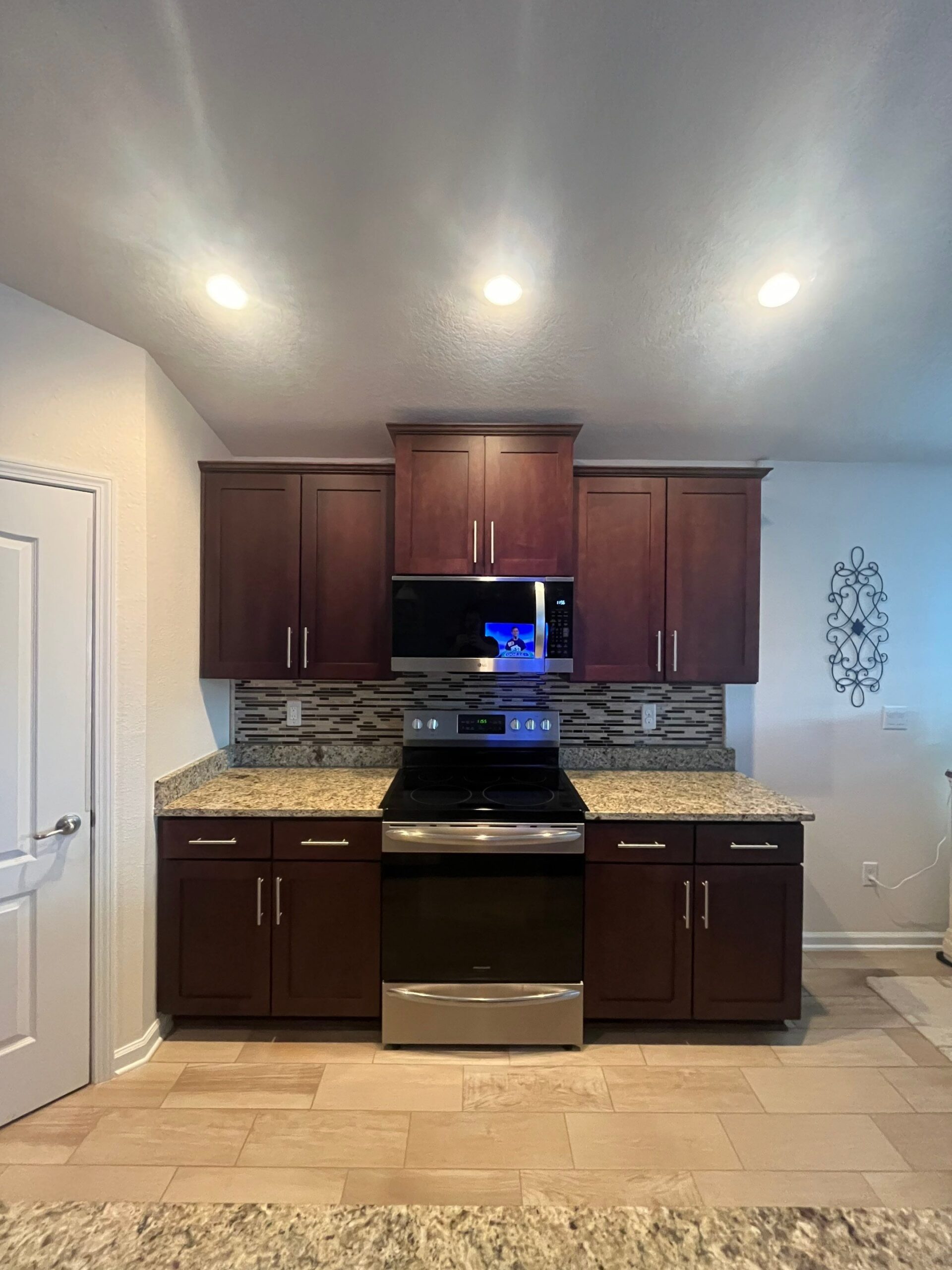 2-Oct 21 2025 03_57pm-2gQx Cabinet refacing Jacksonville kitchen with white shaker cabinets, gray island, and pendant lights over countertop