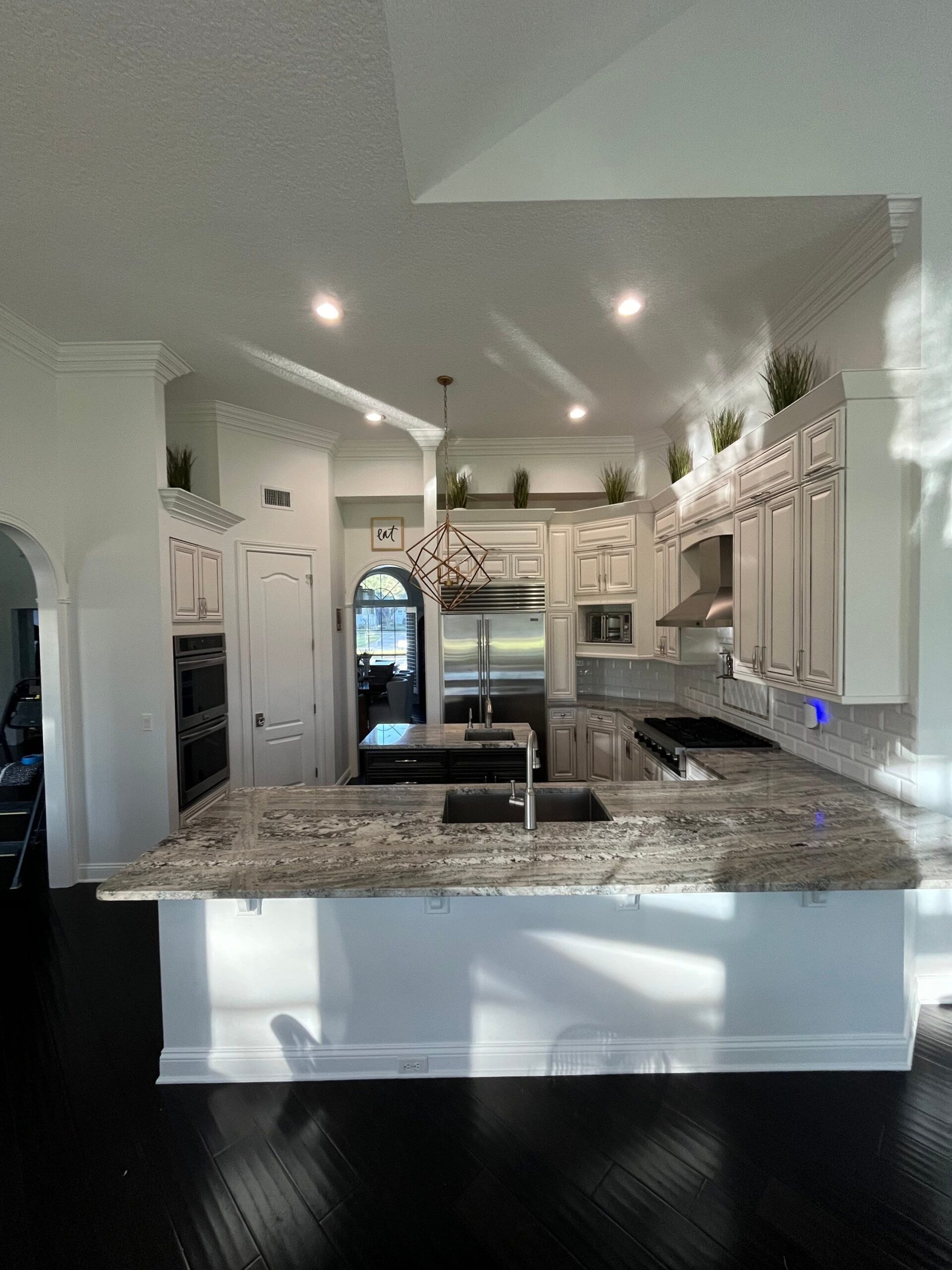 4-Oct 14 2025 12_52pm-e3jF Custom kitchen cabinetry with built-in appliances and island, by custom cabinet makers Jacksonville FL