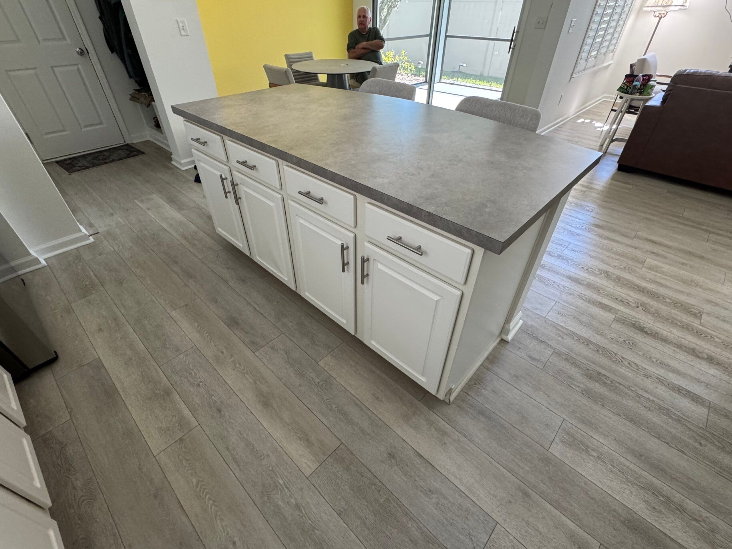 6-Dec 16 2025 02_01pm-CAm7 Kitchen with white shaker cabinets, stainless range hood and island, showcasing custom cabinets Jacksonville